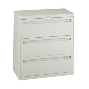 Metallic gray filing cabinet with three horizontal drawers. A lock is visible at the top center, with a key inserted. The cabinet stands on a flat surface against a plain white background.