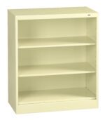 A beige metal bookcase with three shelves is shown. The design is simple and functional, featuring a solid back and an open front. The bookcase is empty, highlighting its spacious storage potential.