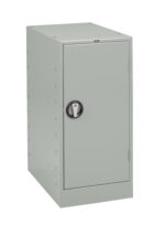 A gray metal locker with a single door is seen in the image. It has a black circular handle for opening and appears to be freestanding with a simple, unadorned design.
