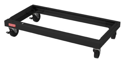 sjakulbnhzyynz3euqc2.jpg A black metal dolly with four swivel casters, designed to transport heavy objects. It has a rectangular frame and a small red sticker on one side with white text.