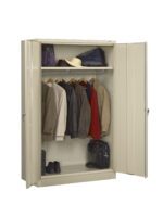 A beige metal wardrobe with open doors reveals a neatly arranged interior. Inside, jackets and coats hang on a rod, with shoes below and hats on a shelf above. A briefcase rests on the bottom shelf.