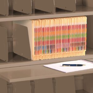 A beige filing cabinet with an open shelf showing a row of color-coded file folders. A pull-out shelf holds a clipboard with white paper and a black pen. Dividers are visible on the shelves, organizing the files.
