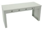 A minimalist, rectangular, light gray metal desk with a smooth surface and open sides. The desk features multiple round cable management holes on its front panel.