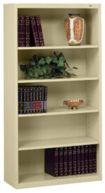 A tall beige bookshelf with five shelves. It holds decorative items, including a vase with ornate patterns, a small plant, a decorative bowl, and several sets of books with matching covers, arranged in an orderly manner.