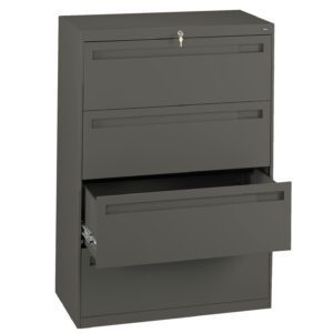 A tall, dark gray metal filing cabinet with three drawers. The top drawer is closed and has a key in the lock, while the middle drawer is also closed. The bottom drawer is partially open, revealing sliding rails inside.