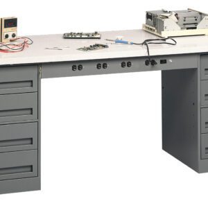 A gray workbench with multiple drawers, featuring a digital multimeter, circuit board, tools, and electronic equipment on top. The workbench has a smooth surface and power outlets underneath.