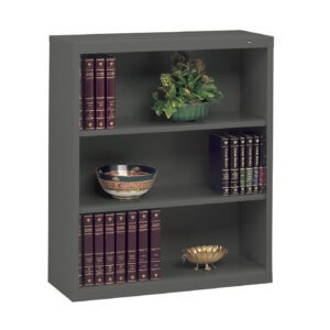 A gray metal bookshelf with three shelves. The top shelf holds a decorative plant; the middle has a bowl with a floral pattern; and the bottom displays a gold decorative bowl. Each shelf is lined with dark red, gold-embossed books.