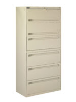 A tall, beige, metal filing cabinet with five drawers, each featuring a horizontal handle. The top drawer has a lock with a key inserted. The cabinet is standing on a white background.