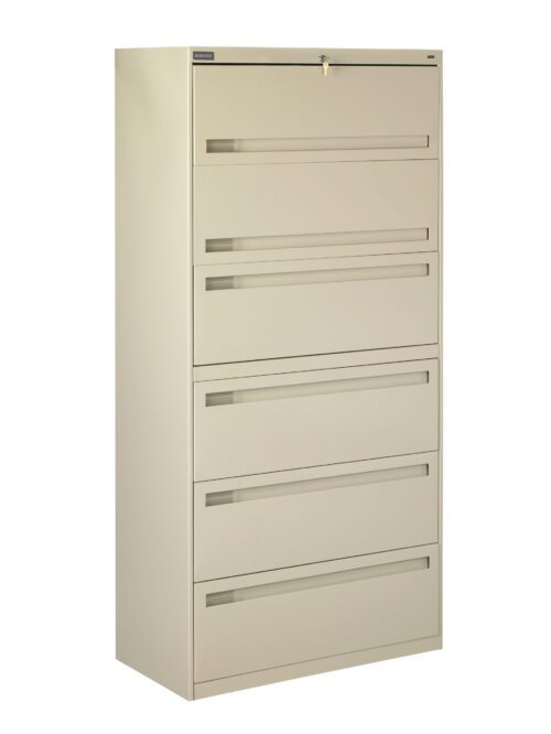 A tall, beige, metal filing cabinet with five drawers, each featuring a horizontal handle. The top drawer has a lock with a key inserted. The cabinet is standing on a white background.