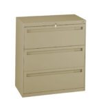 A beige, three-drawer filing cabinet with a lock on the top drawer. The cabinet has sleek, recessed handles on each drawer, and is set against a plain white background.