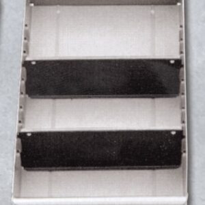 A three-tiered, wall-mounted metal shelf with two black dividers separating the compartments. The shelves are grey, and the unit appears industrial, likely used for organizing tools or materials. Its set against a plain background.