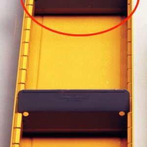 A yellow metal box with a handle at the bottom and two black bars mounted inside. One of the black bars is circled in red. The box has a rectangular shape and includes grooves along the sides.
