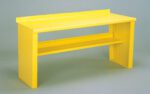 A bright yellow metal bench with a flat top and a lower shelf, set against a plain gray background. The design is simple and industrial, featuring clean lines and sturdy construction.