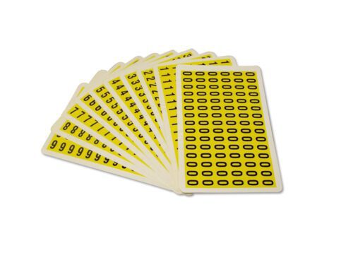 A fanned set of MH-USA Complete Packs of Self-Adhesive Numbers in yellow, with black numbers and symbols, is displayed on a white background. The front card features a grid of black ovals, dimensions: H.0.33 in. x W.0.49 in.
