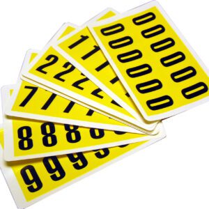 The MH-USA Complete Packs of Self-Adhesive Numbers in yellow include six fanned cards with numbers 0, 1, 2, 7, 8, and 9. The black digits measure H.0.83 in. x W.1.5 in., providing a striking contrast against the vibrant background.