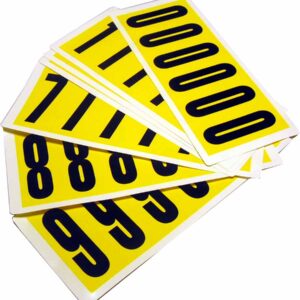 Displayed in a fanned-out arrangement, the rectangular cards with large black numbers set against a bright yellow backdrop are from the MH-USA Complete Packs of Self-Adhesive Numbers - H.38 x W. 3.54 in., featuring numbers 0, 1, 8, and 9 for your organizational needs.