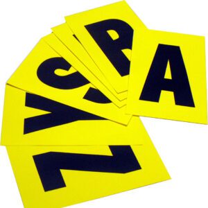 A scattered stack of MH-USA Complete Packs of Self-Adhesive Letters in vivid yellow, featuring large black letters like A, R, S, Y, and Z, are spread out on a flat surface. Each card measures 5.51 inches by 9.06 inches.