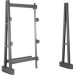 Two gray, freestanding warehouse rack frames with multiple perforations and support beams. The left frame is partially assembled with horizontal beams, while the right frame stands independently without additional components.