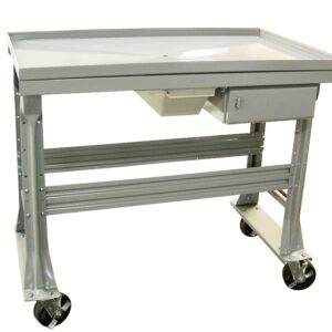 A gray metal utility cart with a flat top and a small drawer underneath. The cart has four sturdy legs and large, black caster wheels for mobility. The design is simple and industrial, suitable for various work environments.