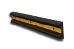 The TCT Heavy Duty Wall Protector features a black rubber design with a yellow center strip, triangular shape, rounded edges, and two mounting screw holes. Its dimensions are 39 3/4L x 6W x 2 1/4 on a white background.