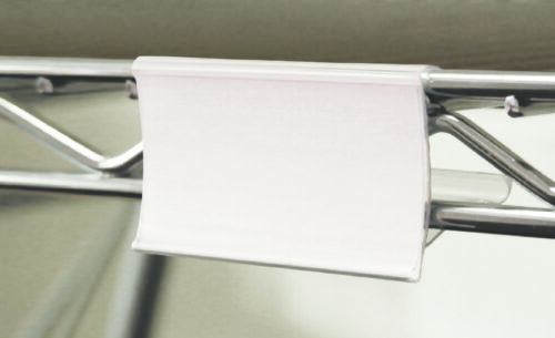 A blank white paper is attached to a metal hanger using an MH-USA Wire Shelving Clip Holder - Pack of 12 - H.1.69 in. x W.2.95 in., set against a neutral backdrop.
