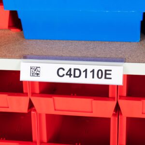 On a shelf, a red storage bin labeled C4D110E features an MH-USA Angled self-adhesive Ticket Holder. A partially visible blue bin sits above it. A QR code on the labels left side highlights efficient organization in action.