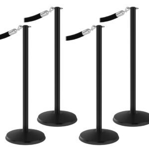 Four Visiontron Prime Flat Top Stanchion Bundles with retractable belts are set in a simple line. The stanchions, equipped with a round base, are perfect for crowd control or queuing.