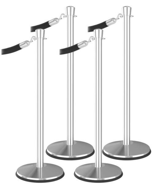 A row of four Visiontron Prime Urn Top Stanchions from the stanchion bundle, featuring black retractable belts, round bases, and a sleek metallic finish—perfect for crowd control or organizing waiting queues.