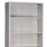 A tall, gray metal shelving unit with three adjustable shelves and perforated sides is shown. The unit is empty and placed against a plain white background.