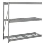 A metal storage rack with three wire mesh shelves, supported by vertical beams. The design is industrial and sturdy, suitable for heavy-duty use, such as in warehouses or garages. The rack is empty and shown against a white background.