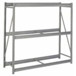 A metal industrial storage rack with two horizontal shelves and support beams. The frame has vertical slotted uprights and cross-bracing for stability. The rack is empty and set against a white background.