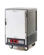 The Metro C535-HFS-L-GYA is a gray, 1/2 height insulated holding cabinet with a full-length solid door, lip load aluminum slides, and wheels. It features control dials for temperature adjustment, operates on 120V and 60Hz at 2000W, ideal for maintaining food temperature during storage and transport.
