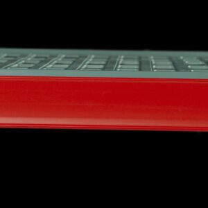 A close-up of a gray keyboard shows a Metro CSM6-RQ Color Shelf Marker for Super Erecta Pro and MetroMax Q Shelving in red, prominently covering part of it. The side view highlights partially visible keys above the vibrant marker against a black background.
