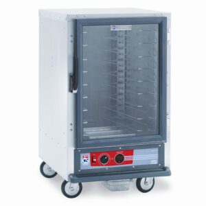 The Metro C515-HFC-U C5 1 Series Holding Cabinet is a mobile, half-height unit with a glass front door, universal wire slides, multiple shelves, and features control dials alongside a digital display on the front panel. It operates at 2000W and 60Hz for efficient performance.
