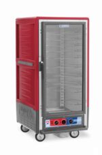 The Metro C537-MXFC-U C5 3 Series is a 3/4 height insulated food transport cabinet in red with gray accents, featuring universal wire slides, a clear front door with metal racks, bottom control panel with dual dials, and operates on 220-240V. The brand logo is prominently displayed on the side.