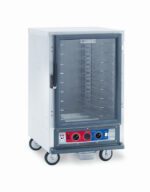 The Metro C515-CXFC-U C5 1 Series Cabinet is a half-height stainless steel food warmer with a transparent door showing multiple shelves. It features control knobs and indicators on the front panel, operates at 220-240V, and is equipped with four wheels for easy mobility.