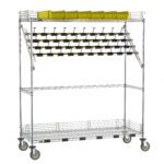 This 24 x 60 x 68 metal storage rack on wheels features three shelves: top with yellow bins, middle adorned with binder clips, and an empty bottom shelf, similar to the Metro CPC56EC Super Erecta Wire Catheter Procedure Carts bulk storage style.