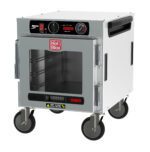 The Metro HBCN4-AC-UC HotBlox Narrow 4-Pan Insulated Undercounter Holding Cabinet is a stainless steel, portable food warmer with an 875W, 60Hz power system. It includes a clear glass door, an analog controller with a temperature dial, side handles for mobility, and the red Hot Blox logo.