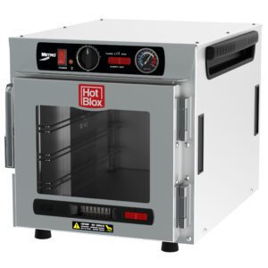 The Metro HBCN4-AC-CT HotBlox Narrow 4-Pan Insulated Countertop/Stacking Holding Cabinet features a clear door, an analog controller for precise adjustments, top panel dials and buttons for temperature settings, operates on 120V, 60Hz, 875W with a NEMA 5-15P plug in a modern compact design.