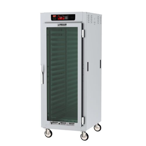 A tall, silver Metro C589X-SFC-LPFS C5 8 Series Insulated Pass-Thru Holding Cabinet with a clear glass door, digital top controls, Lip Load Aluminum Slides, multiple shelves, and four wheels for mobility. It operates at 220-240V.