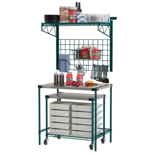 The Metro CR2436PTSW Prep Table with SmartWall & Cart is a green metal kitchen station on wheels, featuring shelves for tomato cans, trays, utensils, and condiments. It has paper stacks below and grid storage above, making it ideal for organizing various kitchen supplies.