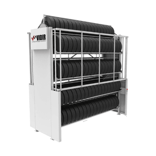 A large tire rack holding multiple black tires is organized in vertical stacks, utilizing automated storage for efficiency. The sturdy white structure, displaying a logo on the side, is designed for optimal storage or display.