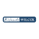 Blue rectangular logo featuring the text Richards-Wilcox in white. The word Richards is stylized and separated by a vertical line from WILCOX in bold capital letters, embodying expertise in inventory organization and hospital supplies storage solutions.