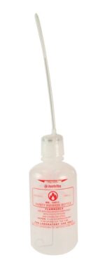 A clear Justrite 32Oz Wht Sfty Squeez Bottle with a long, thin nozzle features flammable in red text and prominently displays the brand name Justrite on its label.