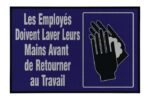 The sign, with a dark blue backdrop and white text, reads Les Employés Doivent Laver Leurs Mains Avant de Retourner au Travail, featuring a hand-washing icon akin to the Justrite Mat,194 Fren Employee Wash 4X6 for workplace hygiene.