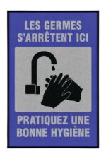 The Justrite Mat, 194 Fren Germs Stop 4X6, features a blue border and gray background with a black faucet icon and washing hands, accompanied by the text: LES GERMES SARRÊTENT ICI PRATIQUEZ UNE BONNE HYGIÈNE, highlighting the importance of good hygiene practices.