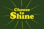 The image features the Choose to Shine message in bold, yellow letters on a Justrite Mat, 195 Choose To Shine 4X6 Gn, with a dark green backdrop. Radiating lines symbolize the collections positive spirit.