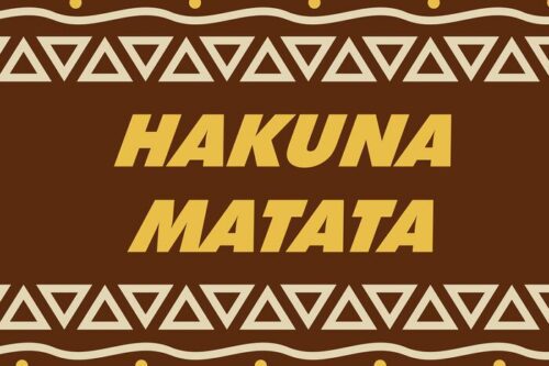 The image displays Hakuna Matata in bold yellow on a brown background, like a Justrite Mat 195 Hakuna Matata 4X6 Br, with repetitive beige triangular patterns along the top and bottom.