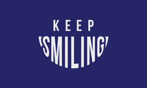 On a vibrant blue background, KEEP SMILING appears with SMILING in a cheerful, curved font. This uplifting message mirrors the positive vibes of the 3X5 Justrite Mat, 195 Keep Smiling Bu design.