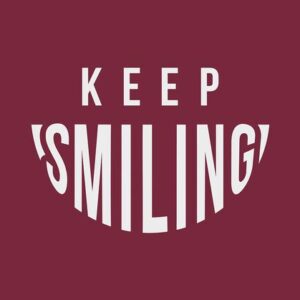 KEEP SMILING text appears on a maroon background, with SMILING creatively styled as a smile, echoing the vibrant appeal of the Justrite Mat at 195 Keep Smiling 3X5 Rd.